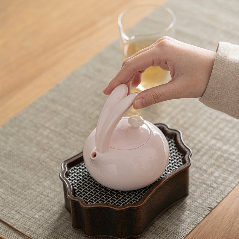 Porcelain pink teapot with cute bunny