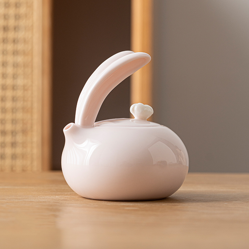 Porcelain pink teapot with cute bunny