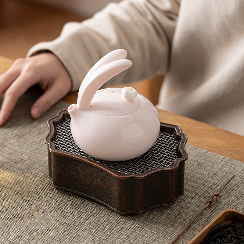 Porcelain pink teapot with cute bunny